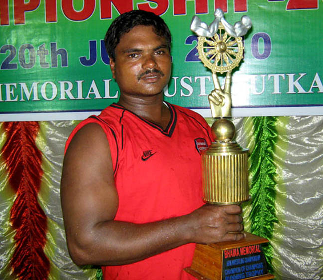 Tapan Kumar Nayak with the champion of champions trophy at the 2nd Bhaina Memorial All-Orissa Arm-wrestling Open Tournament in Bhubaneswar on June 20, 2010.