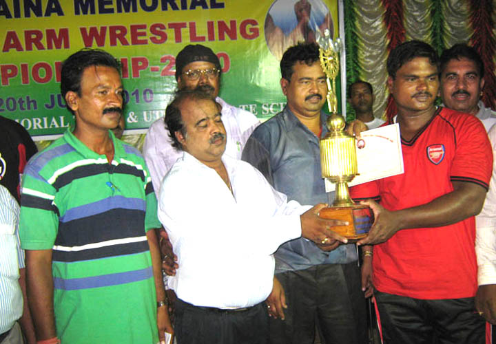 Tapan Nayak receives the champion of champions trophy at the 2nd Bhaina Memorial All-Orissa Open Arm-wrestling Tournament in Bhubaneswar on June 20, 2010.