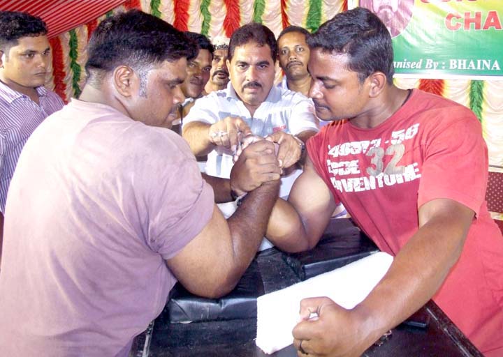 Heavy-weight champion Biswa Mohan Patnaik (Left) fights for title in the 2nd Bhaina Memorial All-Orissa Open Arm-wrestling Tournament in Bhubaneswar on June 20, 2010.