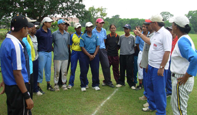 Coaches explain points to players at the women`s National baseball camp in Cuttack