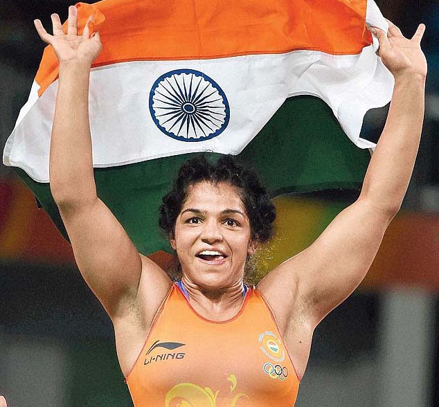 Indian woman wrestler Sakshi Malik cerebrates after winning bronze medal in 2016 Rio Olympic Games.